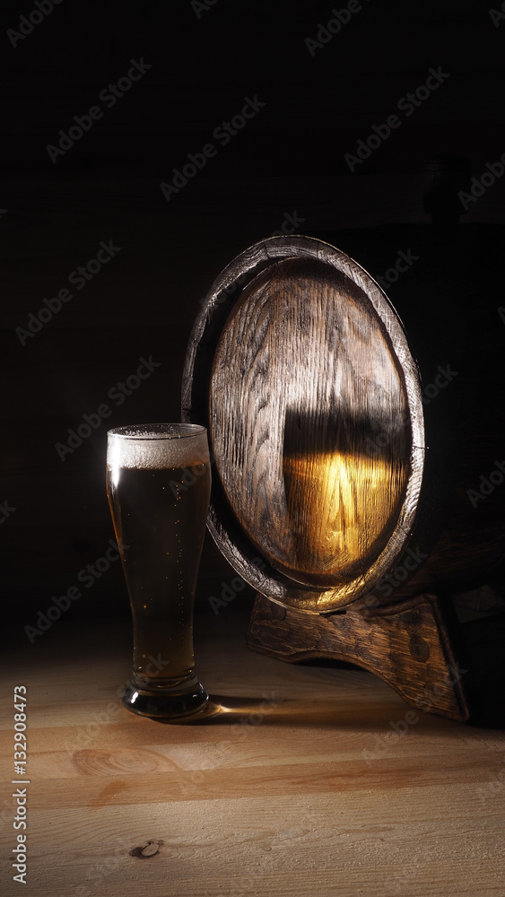 Beer mugs and barrel on a wooden background