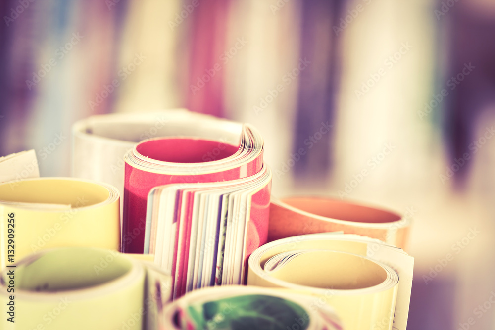 Close up edge of colorful magazine stacking roll Close up edge of colorful magazine stacking roll