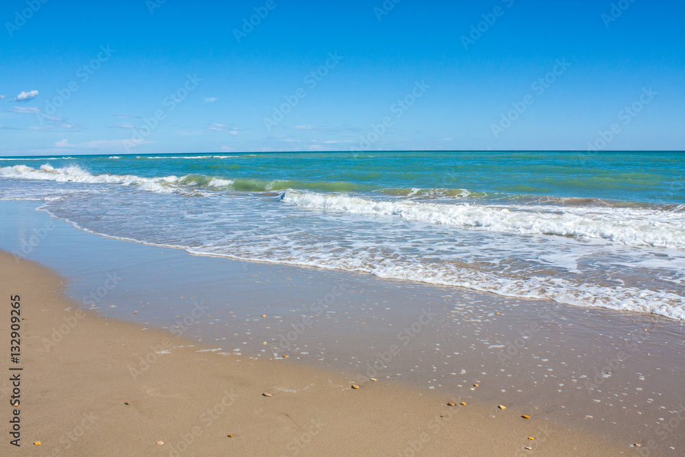 Adriatic Sea coast view. Seashore of Italy, summer sandy beach with clouds on horizon.
