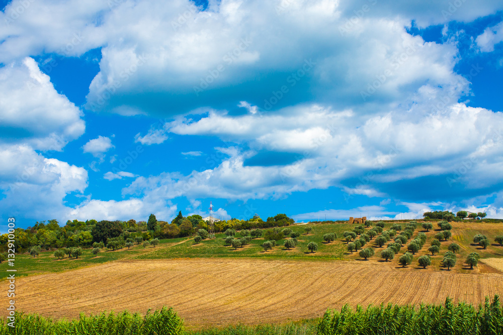 Italy landscape view with clouds on blue sky, Italian fields.
