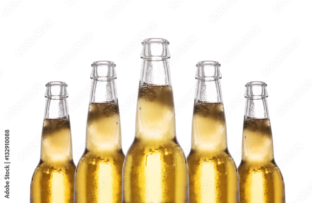 Close-up bottles of frozen lager beer, isolated on white background Close-up bottles of frozen lager beer, isolated on white background
