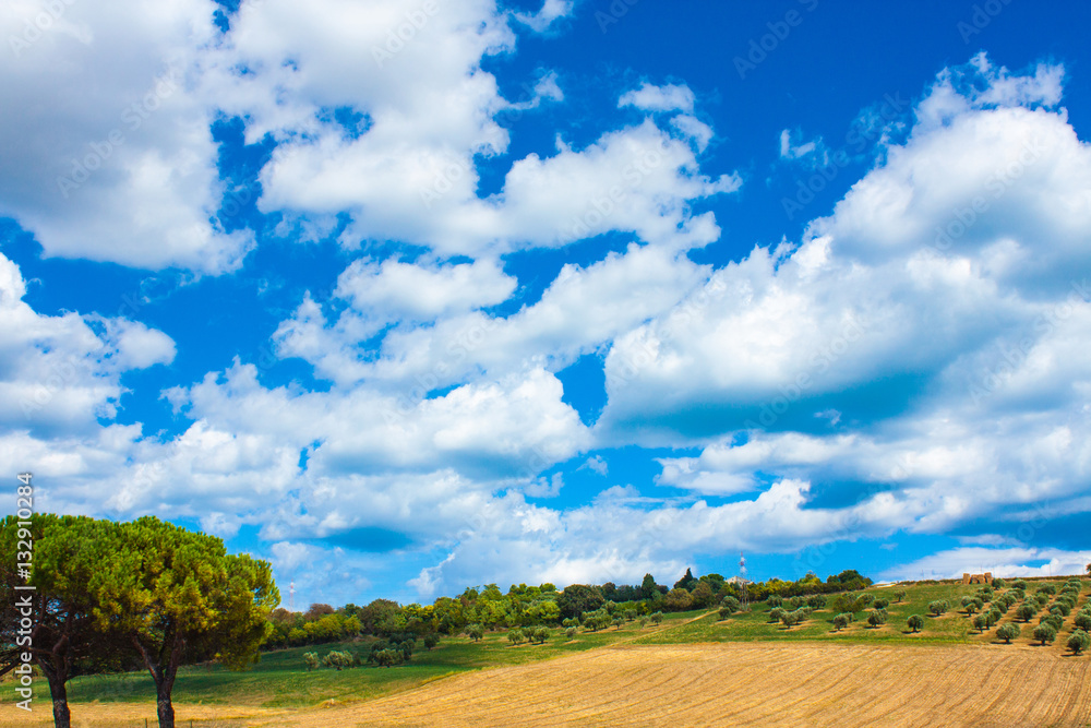 Italy landscape view with clouds on blue sky, Italian fields. Italy landscape view with clouds on blue sky, Italian fields.