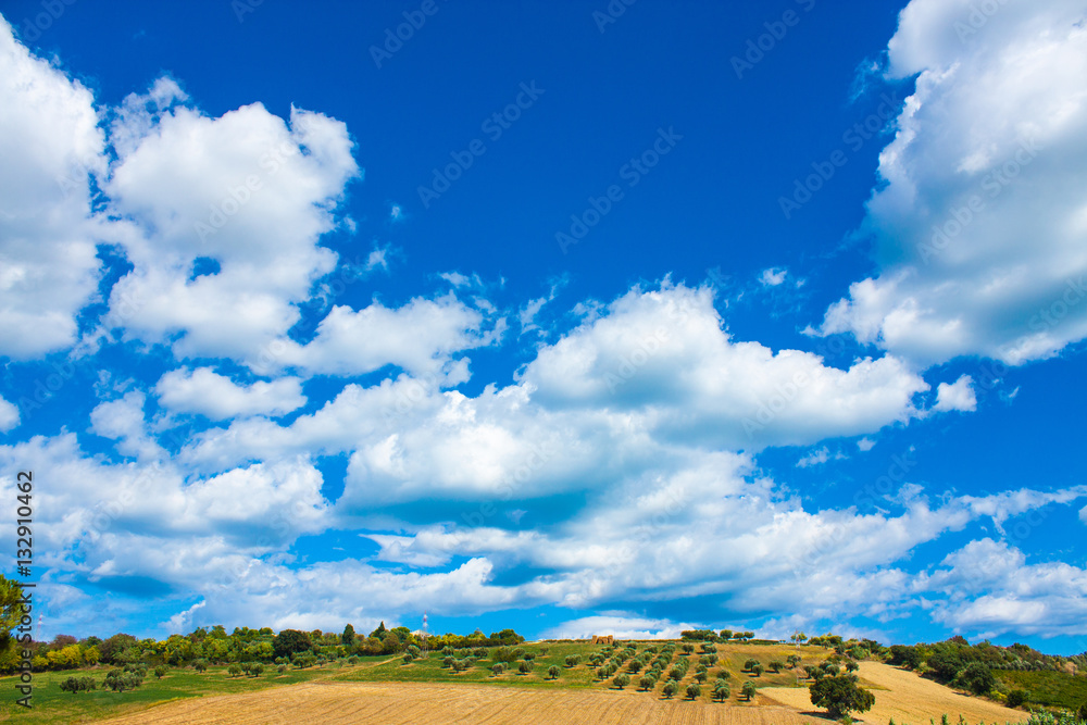 Italy landscape view with clouds on blue sky, Italian fields.