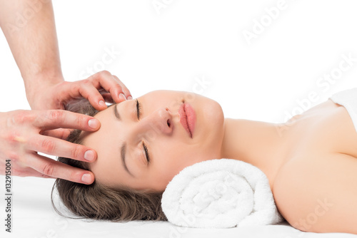masseur's hands and face of a young girl on a massage table