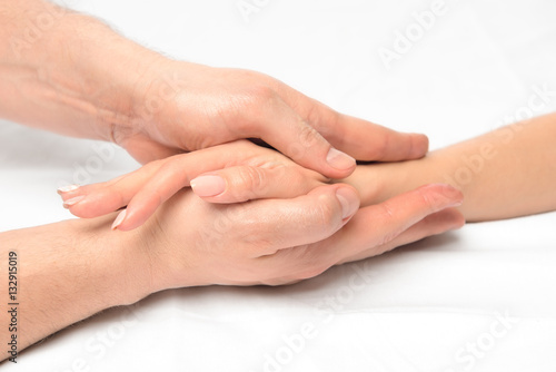 female hand in male hands closeup, stroking massage