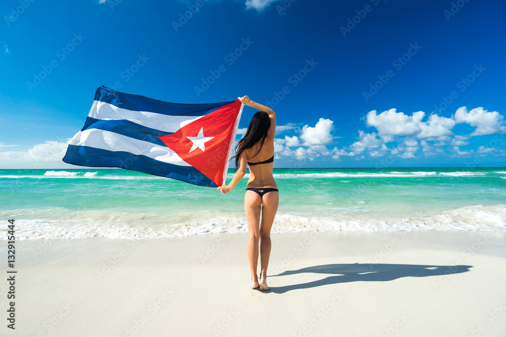 Beautiful young girl in black bikini swimsuit with flag of Cuba Stock Photo  | Adobe Stock