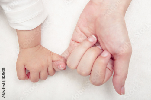 Mom and Baby Hands Promise. friendship of generations, Soft focu