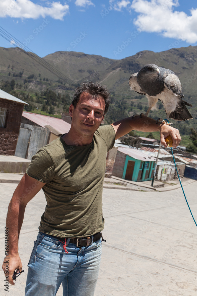 Caucasian man with trained eagle over his arm Caucasian man with trained eagle over his arm
