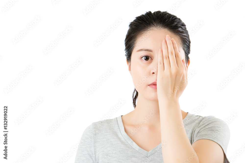 asian woman reviewing eyesight. closing one eye with hand asian woman reviewing eyesight. closing one eye with hand