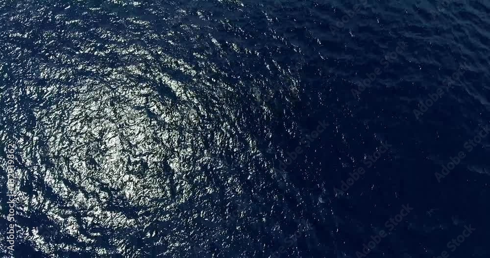 Sun reflection in the ocean, aerial shot. Camera spin. Rotation shot of blue sea with sun glitters. Sun reflection in the ocean, aerial shot. Camera spin. Rotation shot of blue sea with sun glitters.