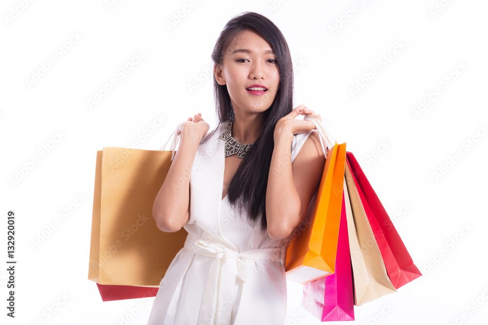 Beautiful Asian women holding shopping bags in her hands feeling so happiness isolated on white background with a copy space Beautiful Asian women holding shopping bags in her hands feeling so happiness isolated on white background with a copy space