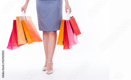 Many shopping bag in women hands after clearance sale with a copy space isolated on white background