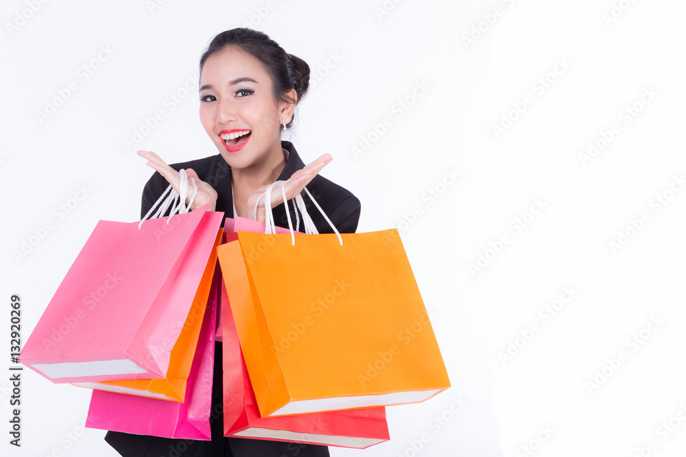 Beautiful Asian women holding shopping bags in her hands feeling so happiness isolated on white background with a copy space Beautiful Asian women holding shopping bags in her hands feeling so happiness isolated on white background with a copy space
