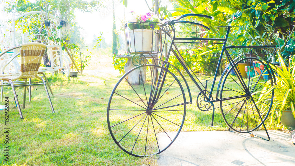Vintage bicycle with flower in garden - vintage effect filter st