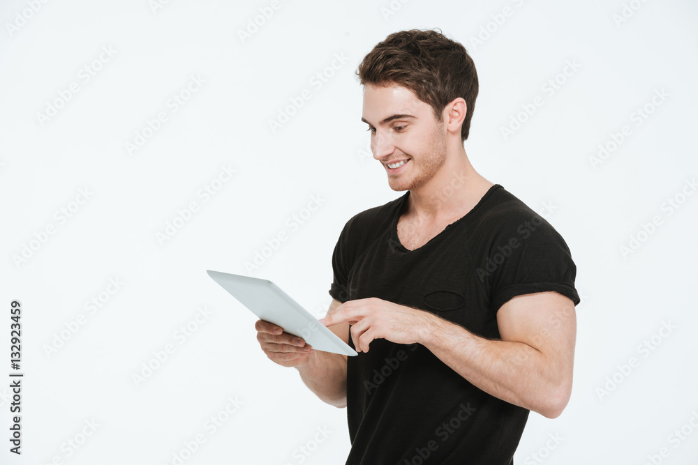 Young happy man using tablet computer. Young happy man using tablet computer.