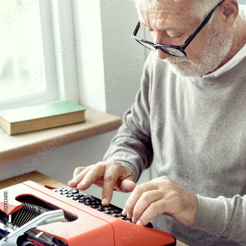 Senior Adult Typing Typerwriter concept photo