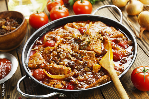 Pork stew with tomatoes and raisins