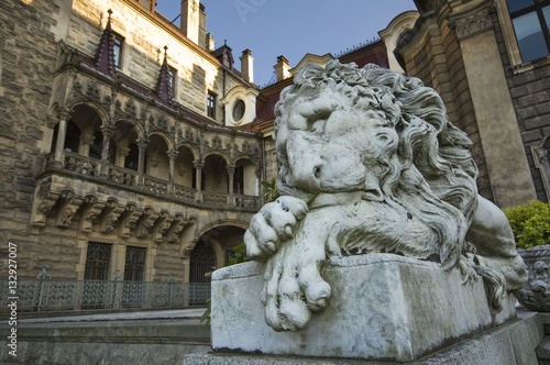 Stone statue of lion in entrance portal of the old castle in Moszna, near Opole, Silesia, Poland
