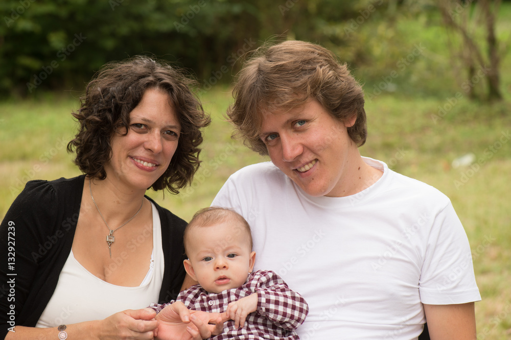 Happy mother and father with baby in park Happy mother and father with baby in park