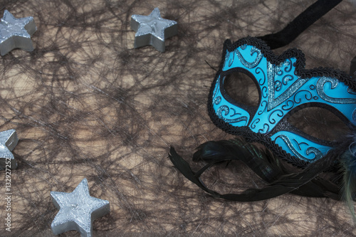 Blue carnival mask with several grey candles in form of stars