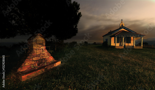 Small church in sunset lights photo