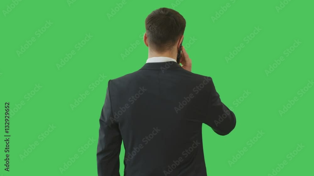Medium Shot of a Handsome Serious-Minded Businessman Talking on the Phone. His Background is Green Screen. Shot on RED Cinema Camera 4K (UHD). Medium Shot of a Handsome Serious-Minded Businessman Talking on the Phone. His Background is Green Screen. Shot on RED Cinema Camera 4K (UHD).
