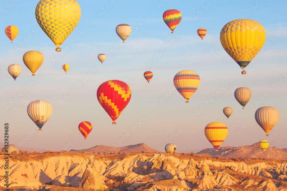 Fototapeta premium Scenic vibrant view of balloons flight in Cappadocia valley in s