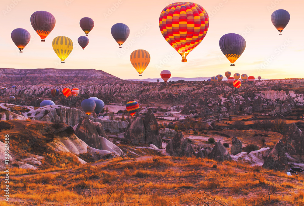 Fototapeta premium Scenic vibrant view of balloons flight in Cappadocia valley in s