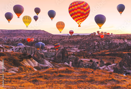 Scenic vibrant view of balloons flight in Cappadocia valley in s photo