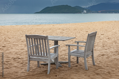 Two sitting place and table in a tropical beach © ppklov