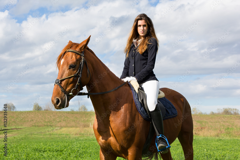 Beautiful young girl in uniform competition ride her brown horse : outdoors portrait on sunny day Beautiful young girl in uniform competition ride her brown horse : outdoors portrait on sunny day