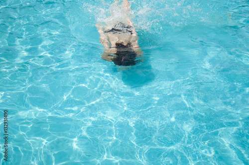 woman wimming under blue water