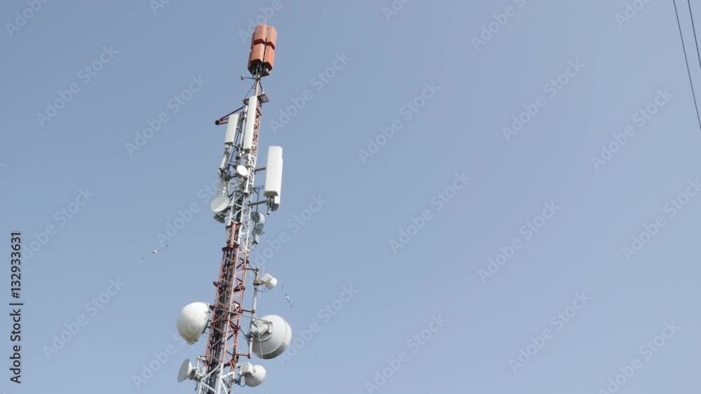 Mobile base station and UHF panels 4K 2160p 30fps UHD slow tilt footage - Cellular repeater tower against blue sky 3840X2160 UltraHD tilting video Mobile base station and UHF panels 4K 2160p 30fps UHD slow tilt footage - Cellular repeater tower against blue sky 3840X2160 UltraHD tilting video