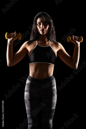 Portrait of a young brunette sporty fitness woman with dumbbell © Serg Zastavkin