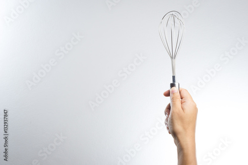 Hand holding stainless balloon whisk