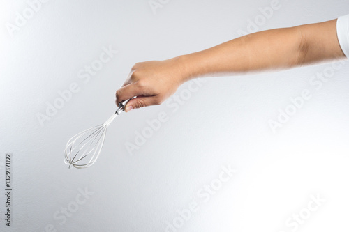 Hand holding stainless balloon whisk