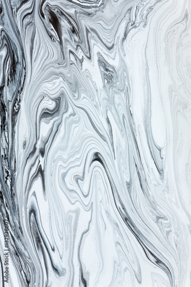 Fototapeta premium White and black paint mixing together creating shapes.