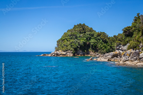 Coastal landscape with blue turquoise ocean water and rocks. 