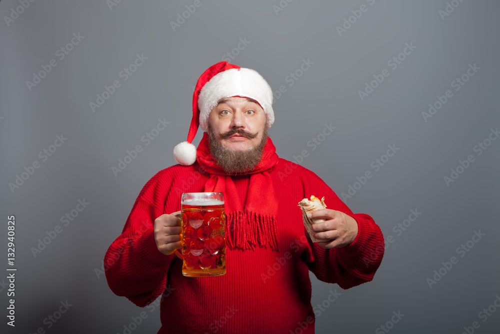 An elderly man with a beard in the cap of Santa Claus with a glass of beer and a hot dog An elderly man with a beard in the cap of Santa Claus with a glass of beer and a hot dog