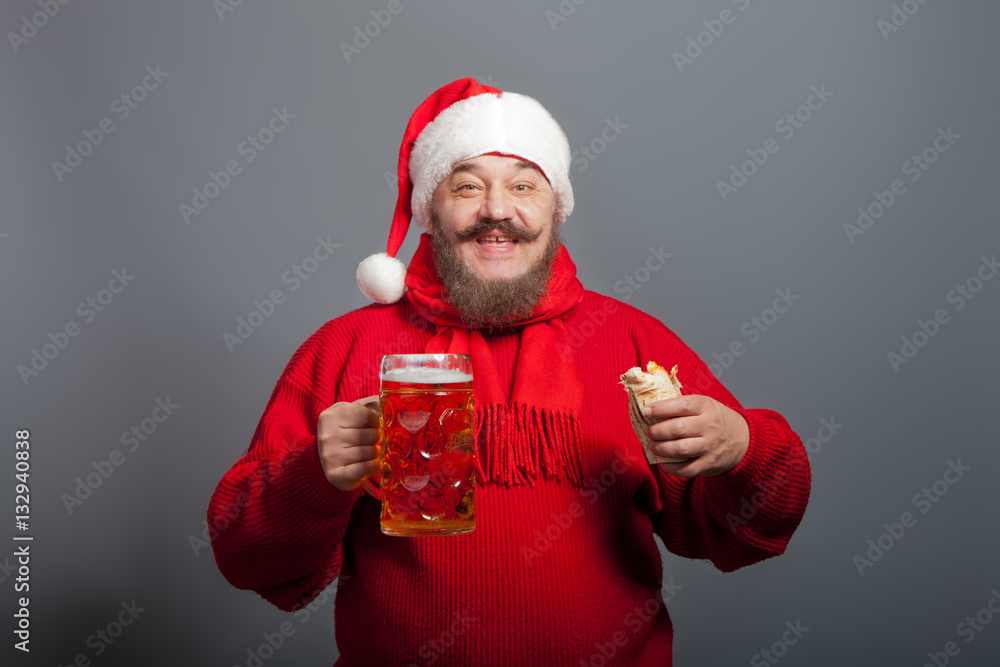 An elderly man with a beard in the cap of Santa Claus with a glass of beer and a hot dog An elderly man with a beard in the cap of Santa Claus with a glass of beer and a hot dog