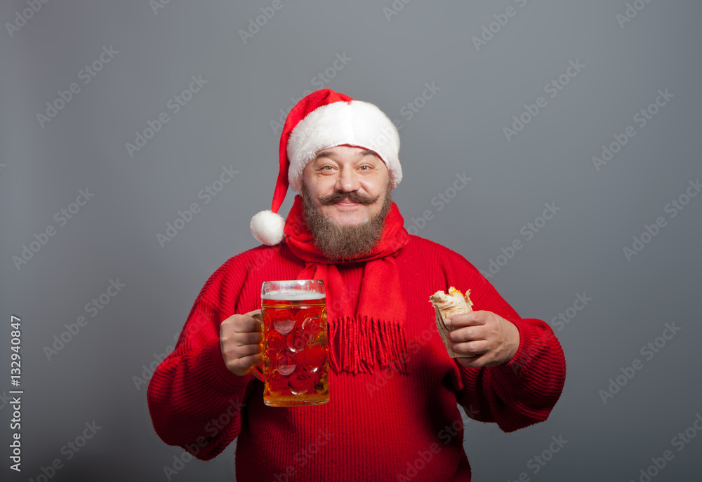 An elderly man with a beard in the cap of Santa Claus with a glass of beer and a hot dog An elderly man with a beard in the cap of Santa Claus with a glass of beer and a hot dog