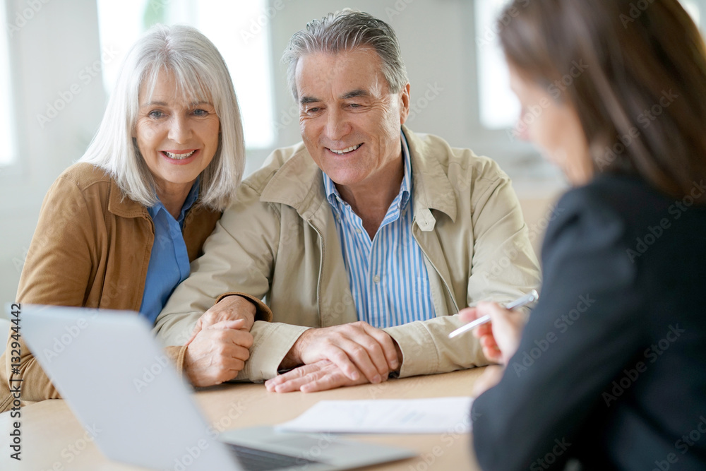 Senior couple meeting financial adviser for investment Senior couple meeting financial adviser for investment