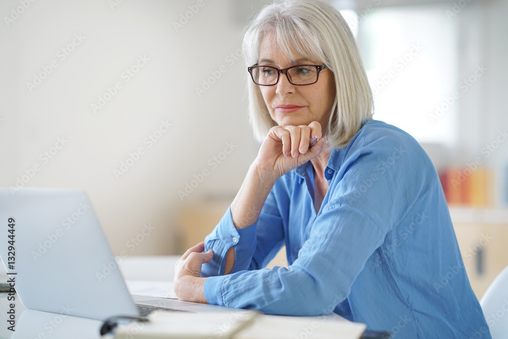 Senior businesswoman working in office Senior businesswoman working in office