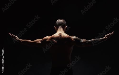 Unrecognizable man shows strong neck muscles closeup