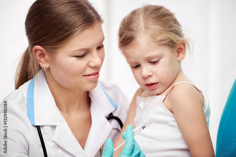 Little girl visiting doctor therapist, having vaccination in clinic. Health care and therapy concept. Little girl visiting doctor therapist, having vaccination in clinic. Health care and therapy concept.