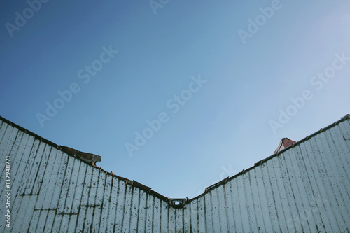 Metal triangle and blue sky forming a geometric background