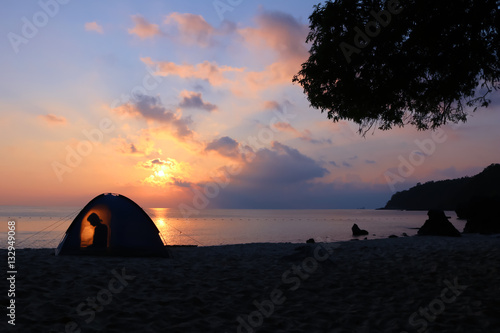 Camping on the beach  sunrise shines through the tent in the morning. 