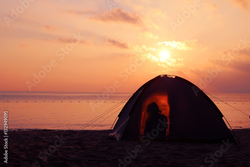 Camping on the beach, sunrise shines through the tent in the morning. 