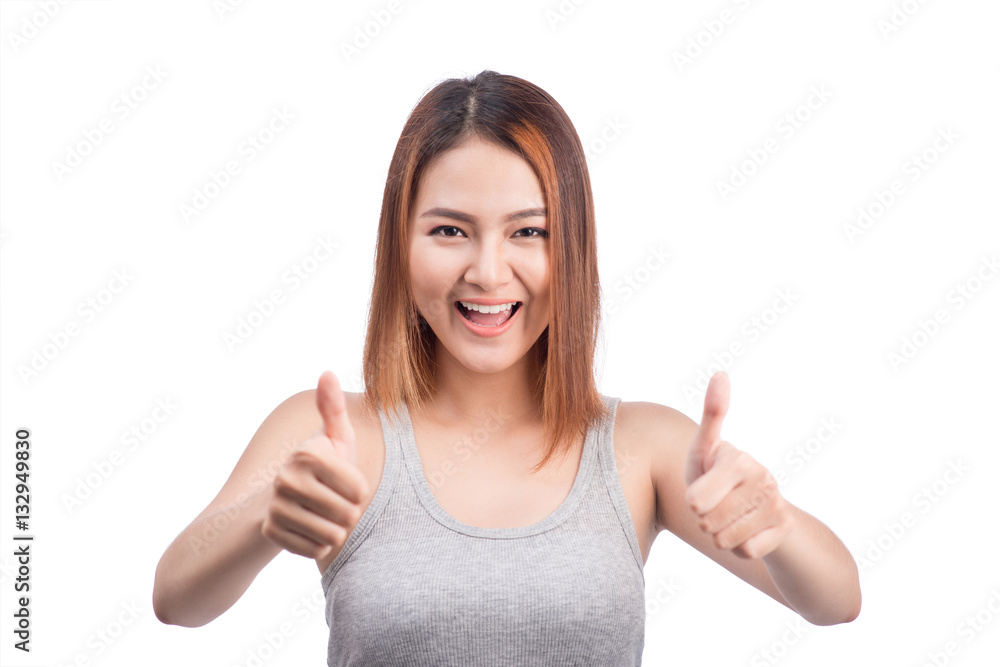 Cheerful lovely girl looking at camera showing thumbs up over wh Cheerful lovely girl looking at camera showing thumbs up over wh