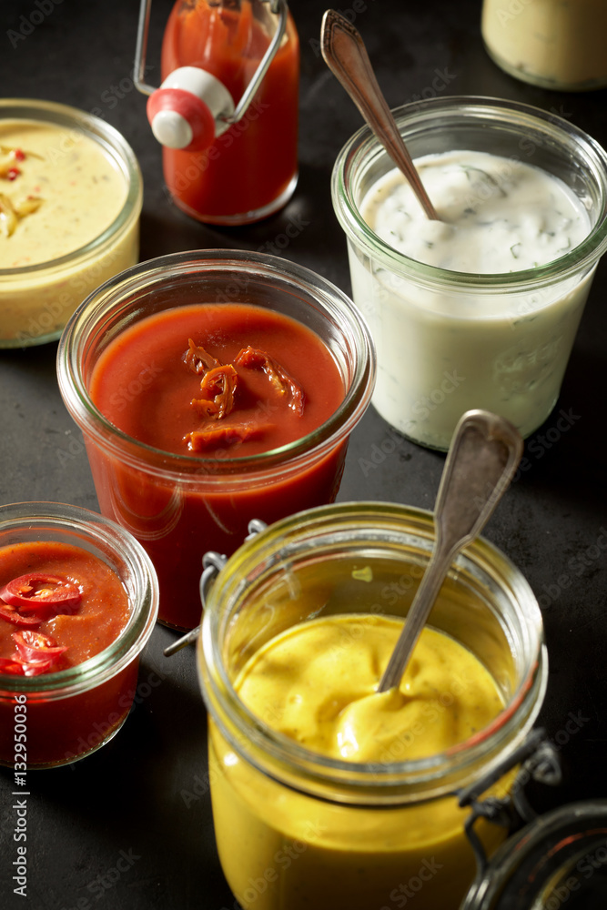 Mustard, ketchup, mayonnaise as dips in jars Mustard, ketchup, mayonnaise as dips in jars